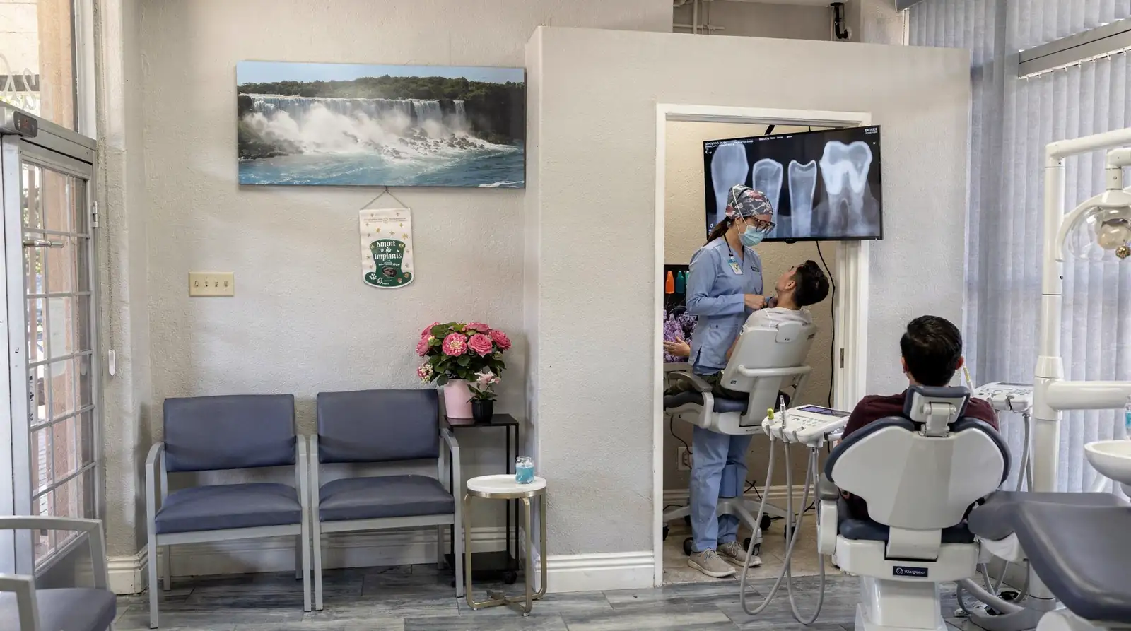 Dental examination in Anaheim Implants & Dental Group office, dentist assessing patient with x-ray imaging.
