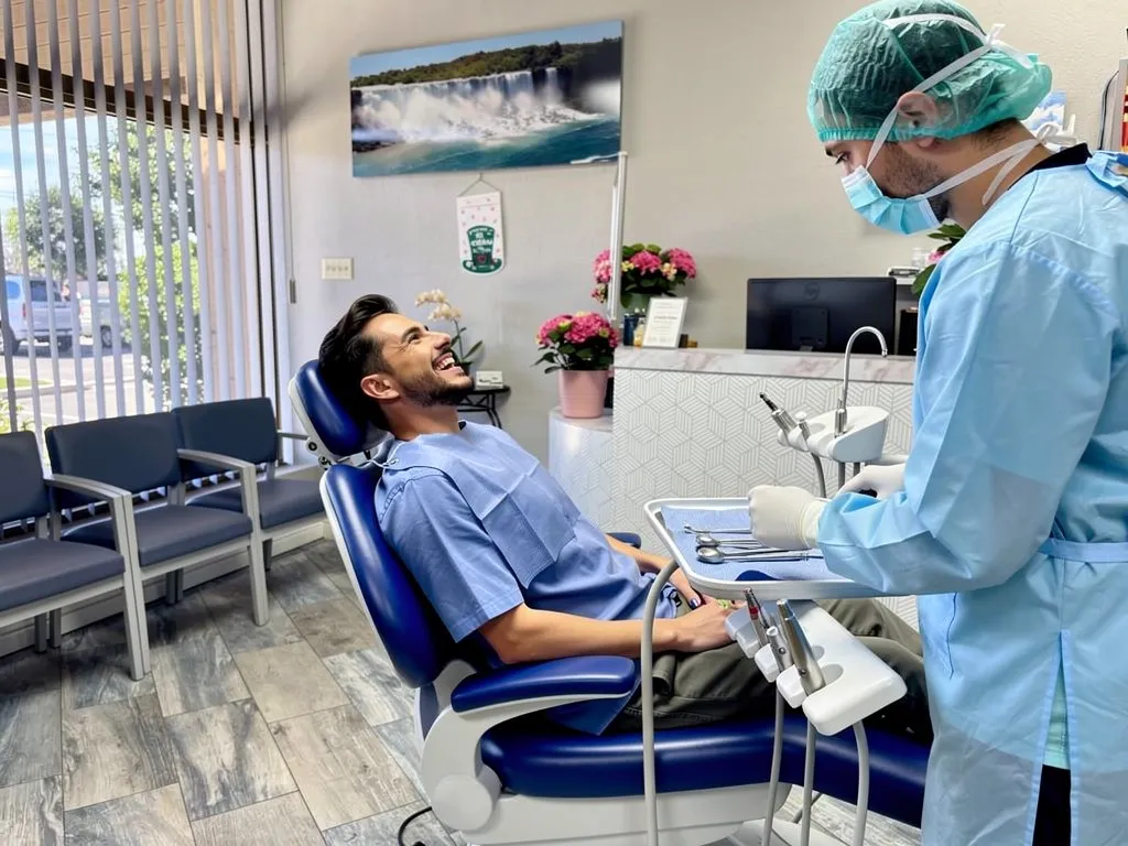 Patient reclined in dental chair undergoing surgical extraction procedure with dental professional in Anaheim, CA.