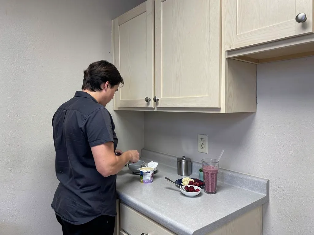 Man preparing soft foods and rinsing with salt water after tooth extraction.
