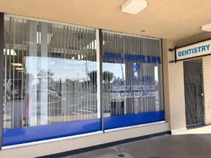 Dentist office window showing Thu B. Nguyen D.M.D., family dentistry, and tooth logo