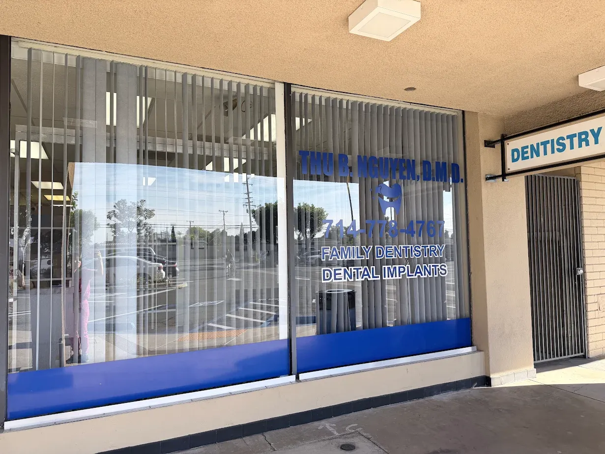 Thu Nguyen, D.M.D. Family Dentistry and Dental Implants signage on Anaheim office window.